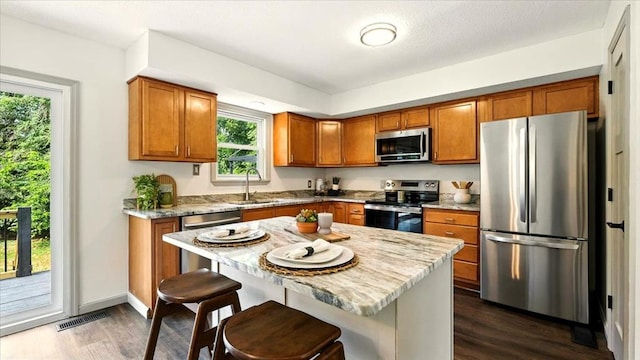 3306 Township Rd Unit 221, Marengo, OH 43334 - kitchen with stainless steel appliances, brown cabinets, and dark wood-type flooring