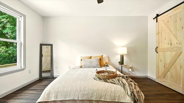 3306 Township Rd Unit 221, Marengo, OH 43334 - bedroom featuring a barn door, dark wood-style floors, and ceiling fan