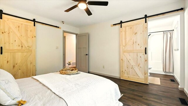 3306 Township Rd Unit 221, Marengo, OH 43334 - bedroom featuring a barn door, dark wood-style flooring, ensuite bathroom, and ceiling fan