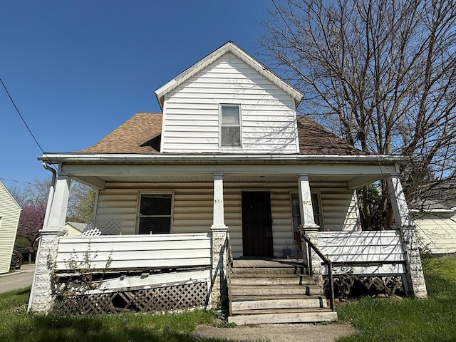 bungalow-style house with a shingled roof and covered porch
