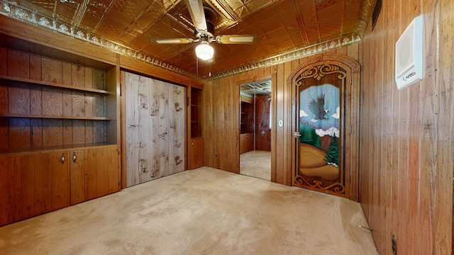 621 Heidi Ln, Mansfield, OH 44904 - empty room with an ornate ceiling, wooden walls, carpet floors, and ceiling fan