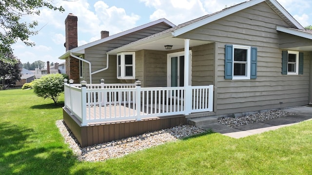 621 Heidi Ln, Mansfield, OH 44904 - back of house featuring a chimney, a lawn, and a deck