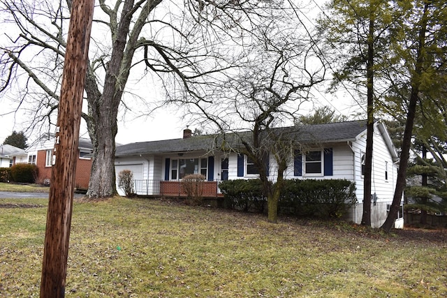 ranch-style home featuring a porch, a garage, brick siding, a chimney, and a front yard