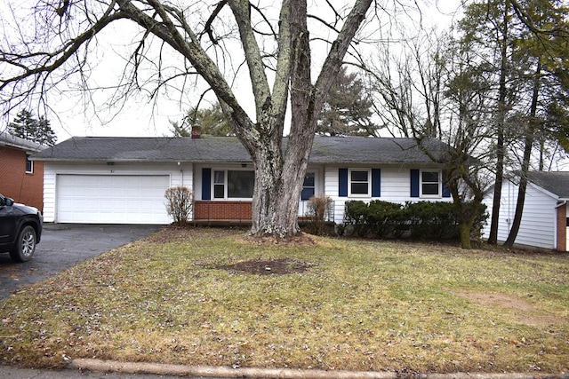 ranch-style house featuring a front lawn, brick siding, driveway, and an attached garage