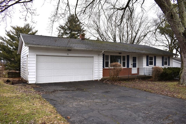 single story home featuring a garage, a chimney, aphalt driveway, a porch, and brick siding