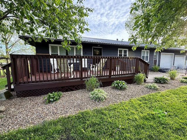 108 Melcher Blvd, Bucyrus, OH 44820 - back of house featuring a deck, metal roof, and a garage