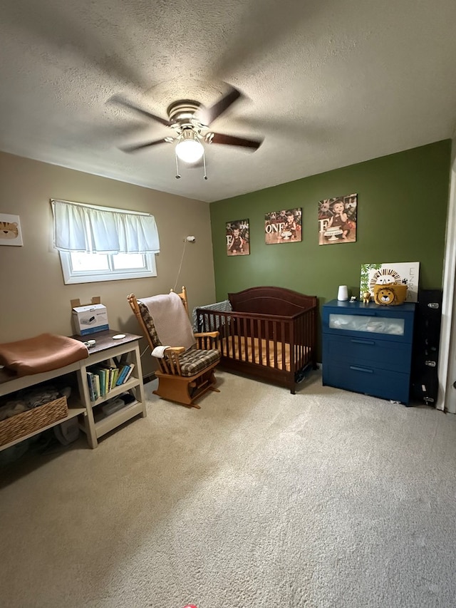 108 Melcher Blvd, Bucyrus, OH 44820 - bedroom with a nursery area, carpet, ceiling fan, and a textured ceiling