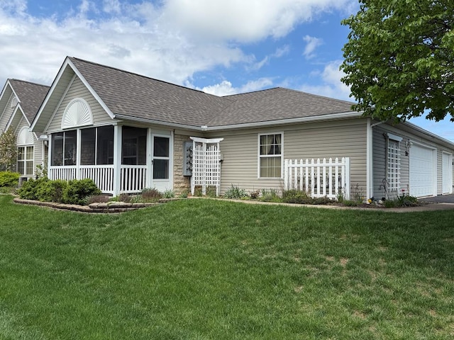 ranch-style home with a sunroom, a shingled roof, and a front yard