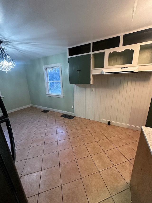interior space with light tile patterned flooring and baseboards