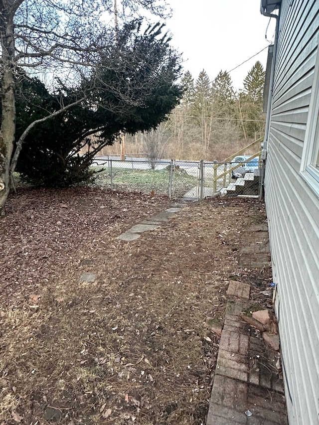 view of yard featuring fence and a gate