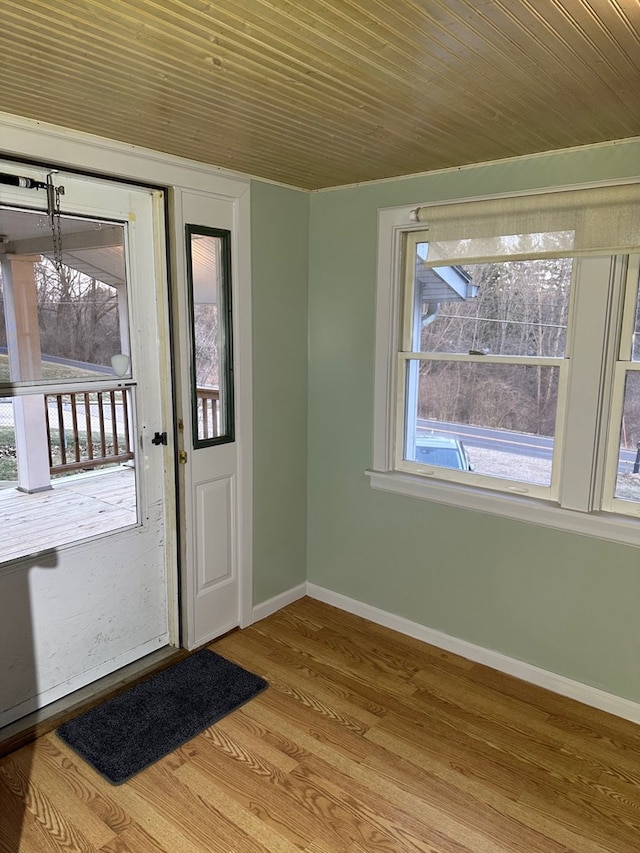 foyer entrance with wood finished floors and baseboards