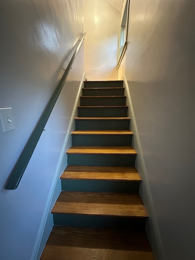 stairway with wood finished floors