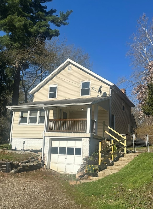 view of front of home with driveway, a chimney, and a garage
