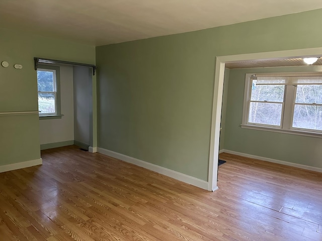spare room with wood finished floors and baseboards