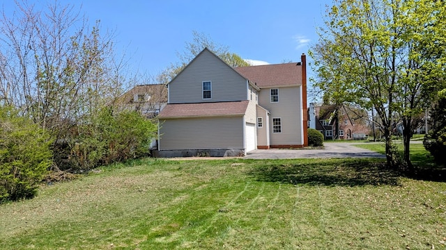 view of home's exterior featuring roof with shingles, a chimney, and a yard