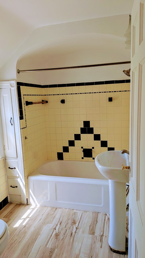 full bathroom with wood finished floors