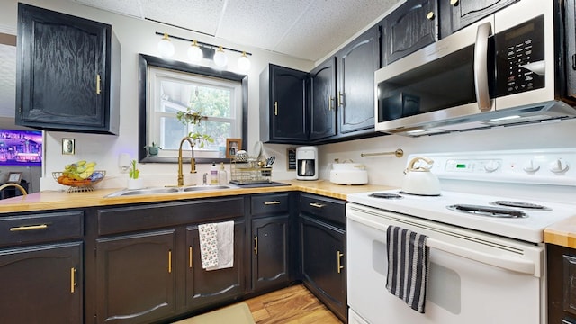 41 Auburn Ave, Shelby, OH 44875 - kitchen with electric stove, stainless steel microwave, a drop ceiling, and light wood-style flooring