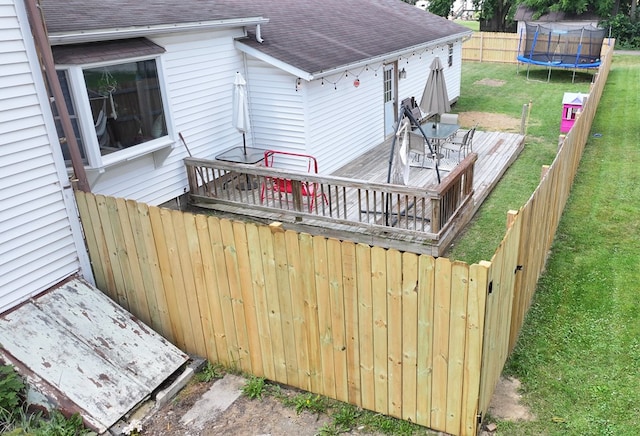 41 Auburn Ave, Shelby, OH 44875 - wooden deck featuring a trampoline and a fenced backyard