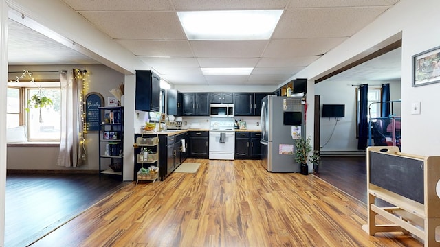 41 Auburn Ave, Shelby, OH 44875 - kitchen featuring a paneled ceiling, stainless steel appliances, light countertops, light wood-style floors, and dark cabinets