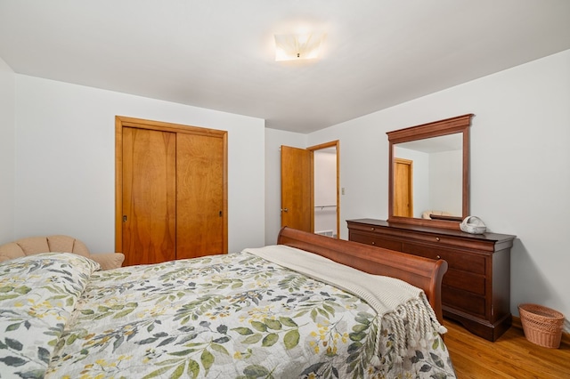 bedroom with hardwood / wood-style flooring and a closet