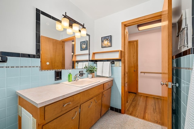 bathroom with vanity and tile walls