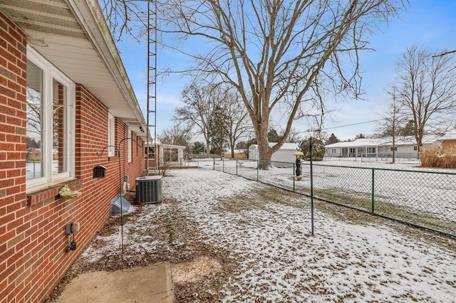 yard covered in snow with central AC unit