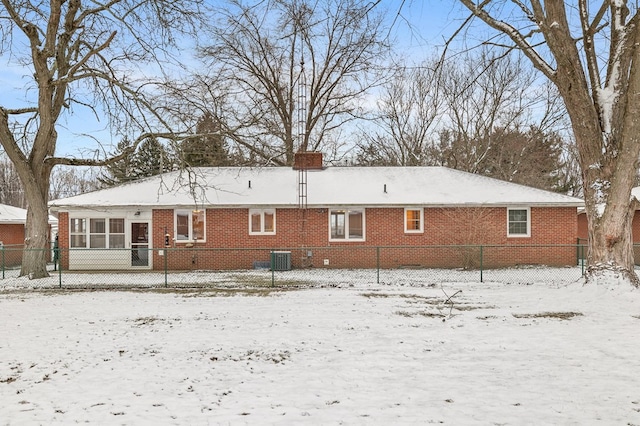 snow covered property with cooling unit