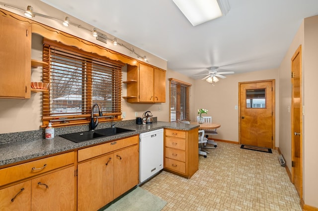 kitchen featuring kitchen peninsula, dishwasher, a healthy amount of sunlight, and sink