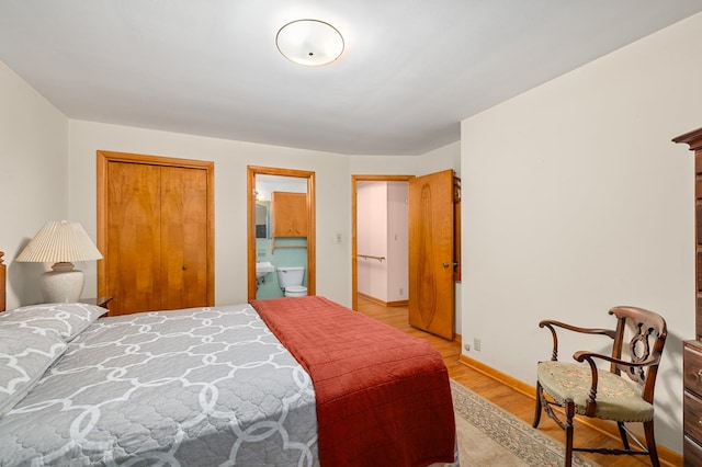 bedroom with connected bathroom, a closet, and light wood-type flooring