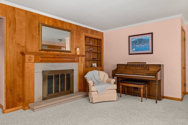 living area with built in shelves, crown molding, and light carpet