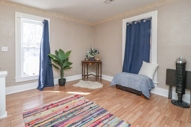 sitting room featuring visible vents, baseboards, and wood finished floors