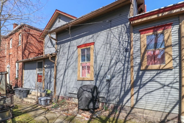 view of side of property featuring entry steps