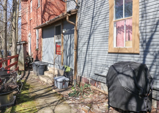 view of side of home featuring crawl space, fence, and entry steps