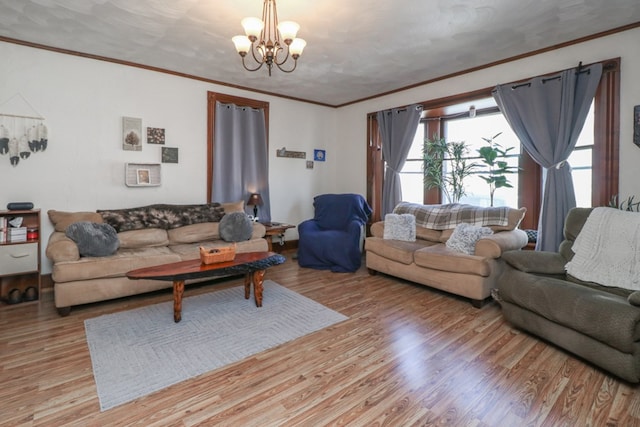 living area featuring a notable chandelier, light wood-type flooring, and ornamental molding