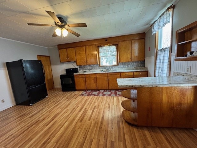 3649 Nazor Rd, Crestline, OH 44827 - kitchen featuring black appliances, open shelves, brown cabinetry, ceiling fan, and wainscoting