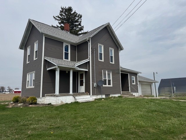 3649 Nazor Rd, Crestline, OH 44827 - view of front facade featuring a chimney, a front lawn, a garage, and covered porch