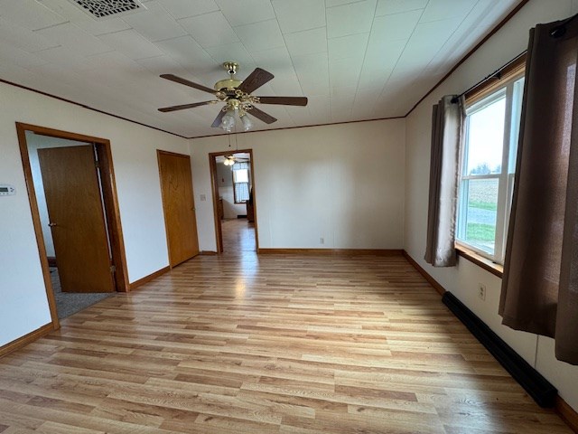 3649 Nazor Rd, Crestline, OH 44827 - unfurnished room featuring healthy amount of natural light, light wood finished floors, ceiling fan, and baseboards