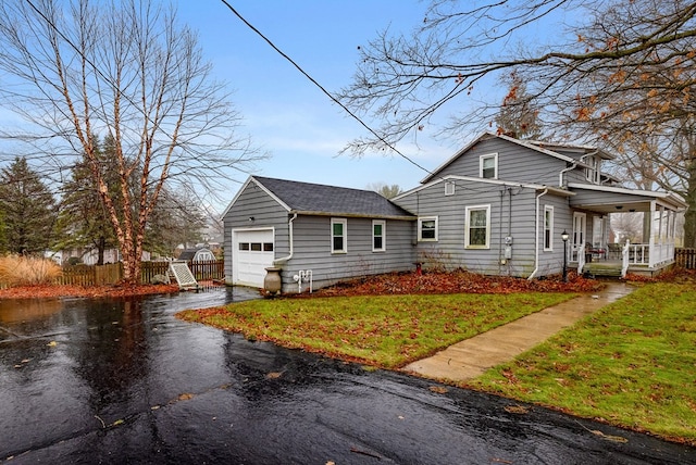 view of front of house featuring a porch, a garage, and a front yard