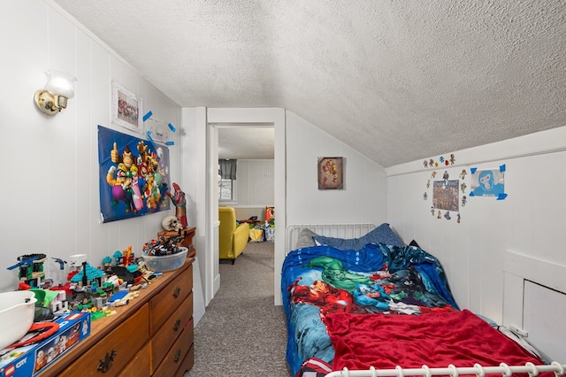 carpeted bedroom featuring a textured ceiling, wood walls, and vaulted ceiling