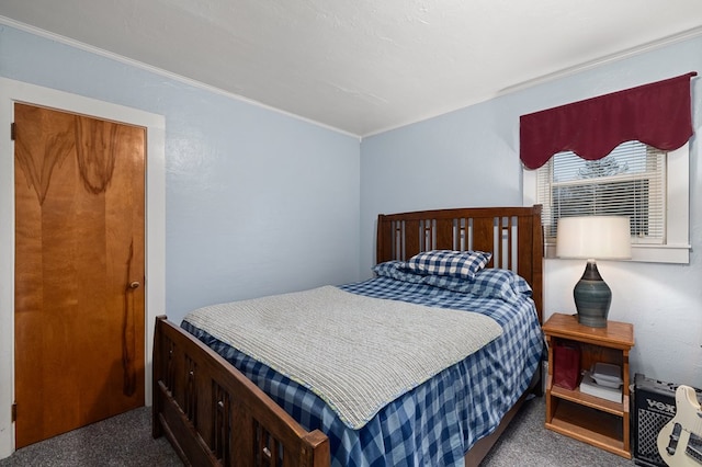 bedroom with dark carpet and ornamental molding