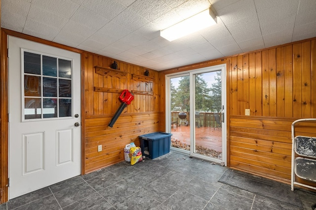 doorway featuring wooden walls