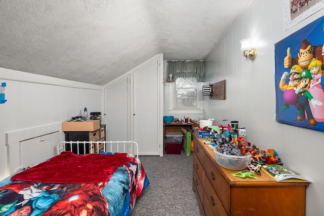 carpeted bedroom featuring a textured ceiling and vaulted ceiling