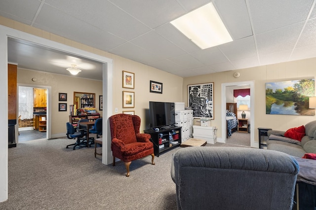 carpeted living room featuring a paneled ceiling