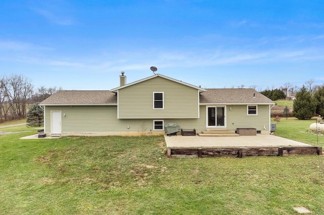 rear view of house featuring a lawn and a patio area