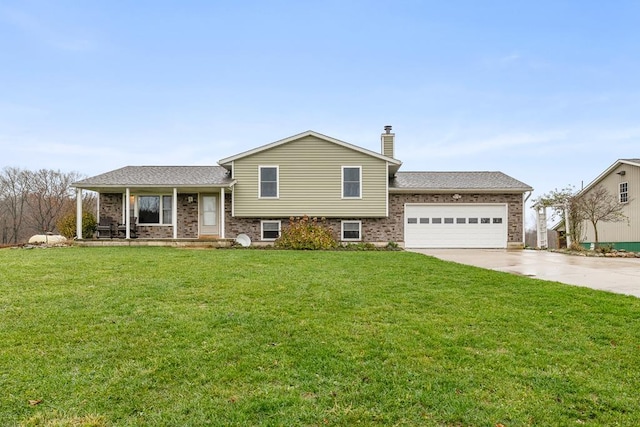 tri-level home featuring a front lawn, covered porch, and a garage