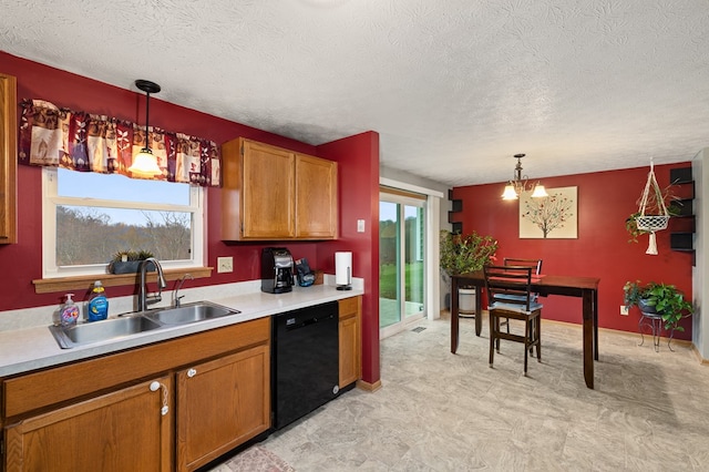 kitchen featuring a healthy amount of sunlight, dishwasher, hanging light fixtures, and sink