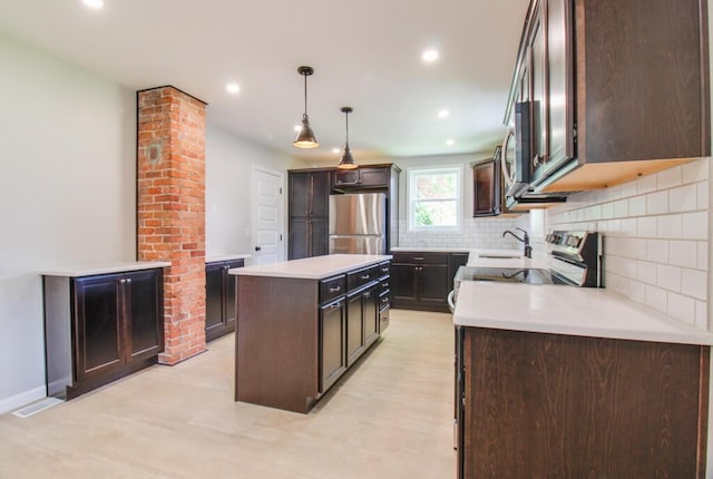 kitchen featuring a kitchen island, stainless steel appliances, dark brown cabinetry, light countertops, and tasteful backsplash