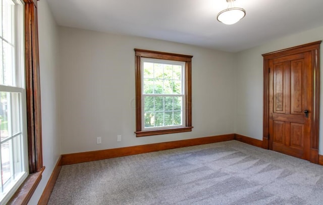 carpeted spare room with baseboards