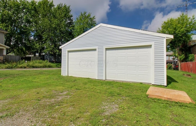 detached garage featuring fence