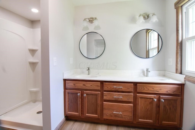 bathroom featuring double vanity, plenty of natural light, and a sink